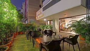 A hotel named 'Hotel Bel Norris' with outdoor seating and potted plants. - Hotel Bel Morris (New Delhi)