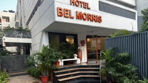 The exterior of Hotel Bel Morris with a modern design, featuring a prominent entrance with steps and potted plants. - Hotel Bel Morris (New Delhi)