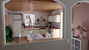 A kitchen with white cabinets, a wooden ceiling, and a window. - Holiday Apartment "Fewo 2 - Osterberg" with Private Terrace, Shared Garden & Wi-Fi (Liebenau)
