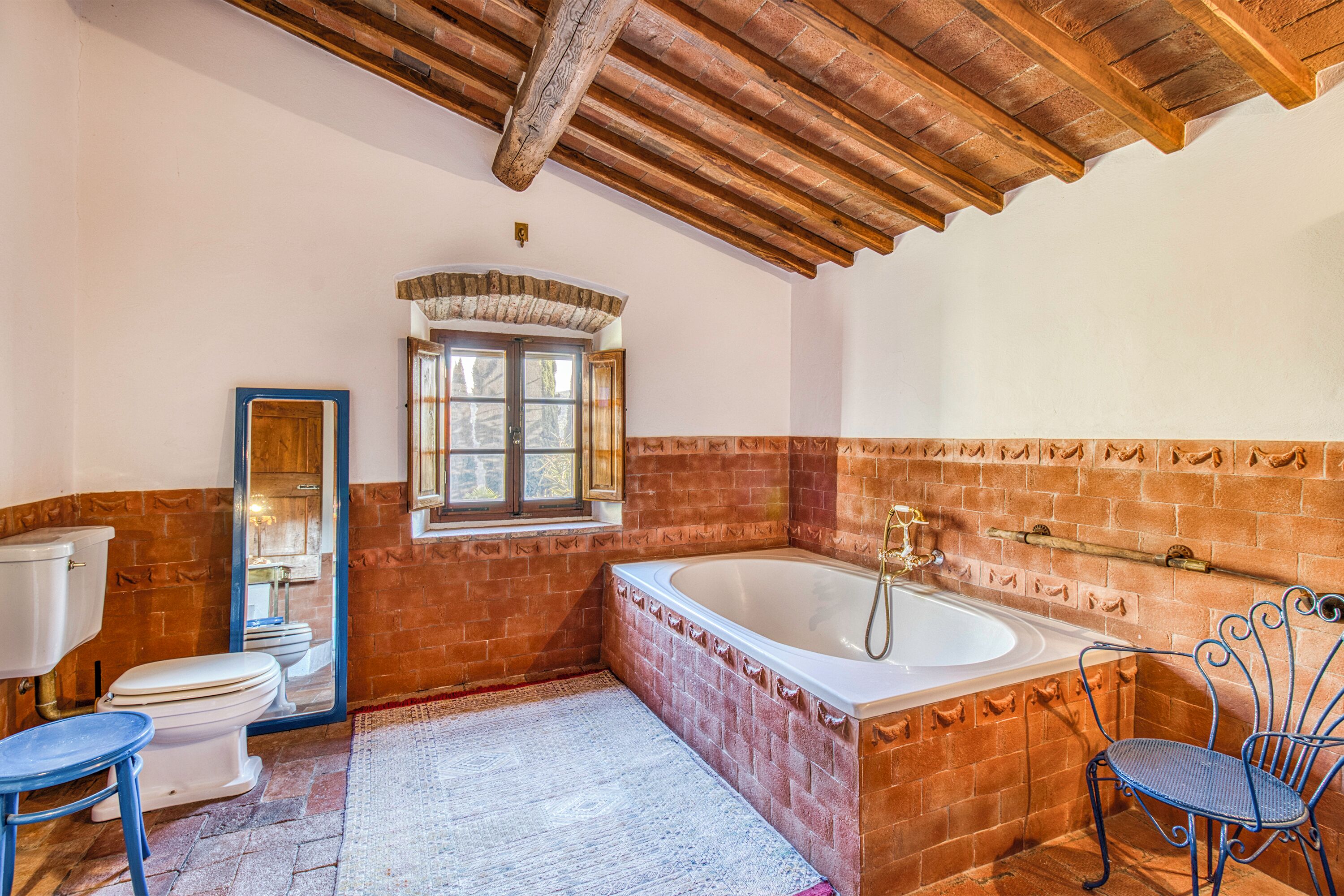 A bathroom with a bathtub, toilet, and sink.