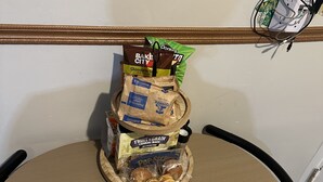 A stack of snack bags on a table with a wall decoration. - This special place is close to everything, making it easy to plan your visit.  (Smyrna)