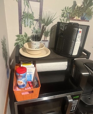 Convenient kitchenette with microwave, refrigerator, and coffee maker.