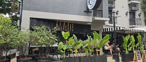 A building with a large circular sign featuring a monkey logo and the text "Monkey Manila."