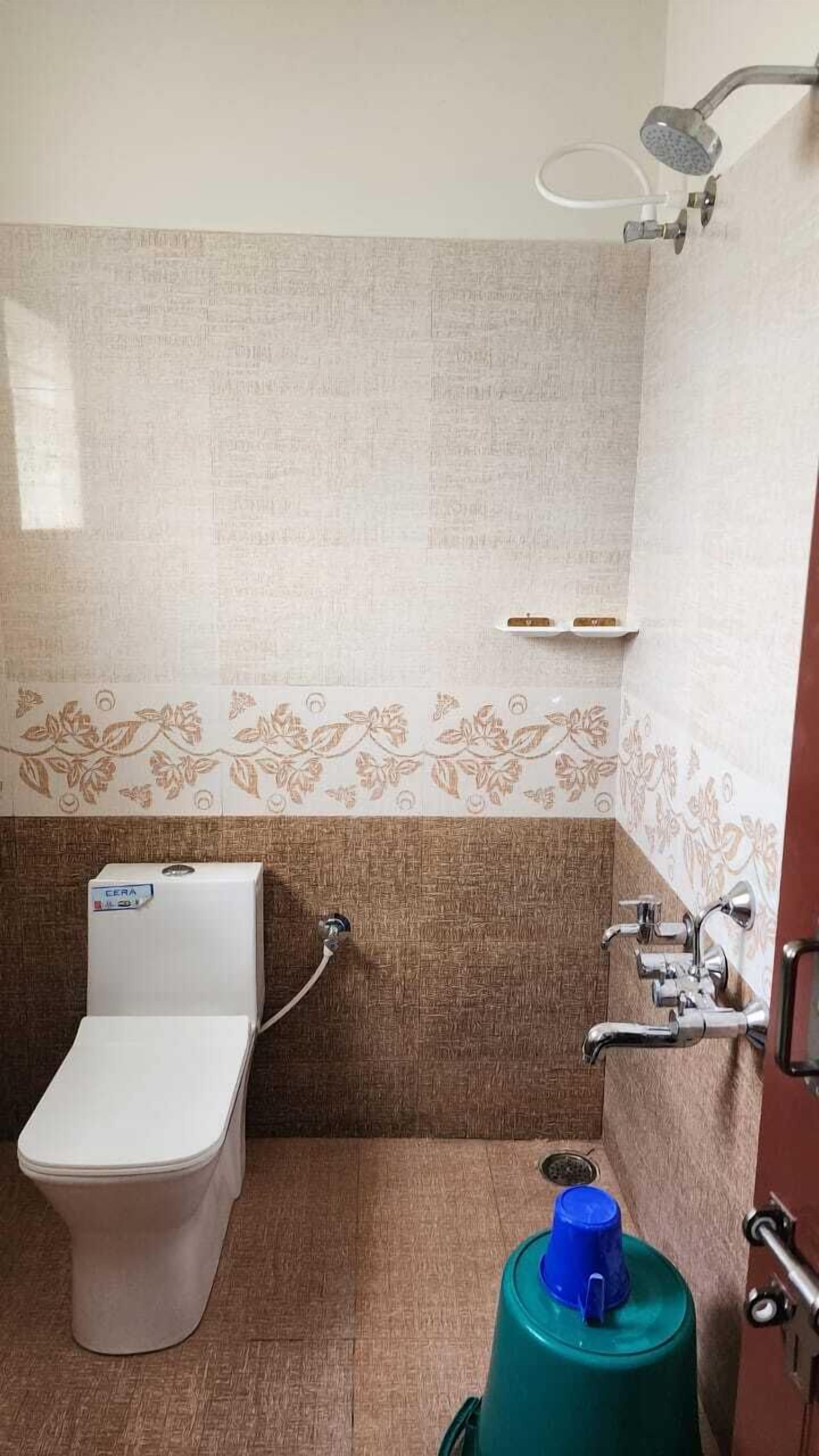 A bathroom with a toilet, shower, and a green water dispenser.