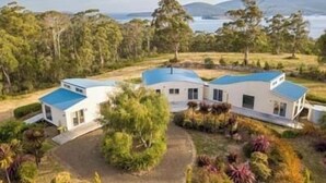 A modern house with a blue roof, surrounded by a well-maintained garden and a view of the sea. - NewHaven, private retreat overlooking Dover Bay (Dover)