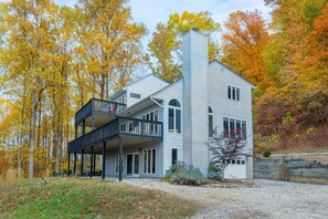 Enjoy a cozy retreat with a fireplace and balcony overlooking a wooded area.