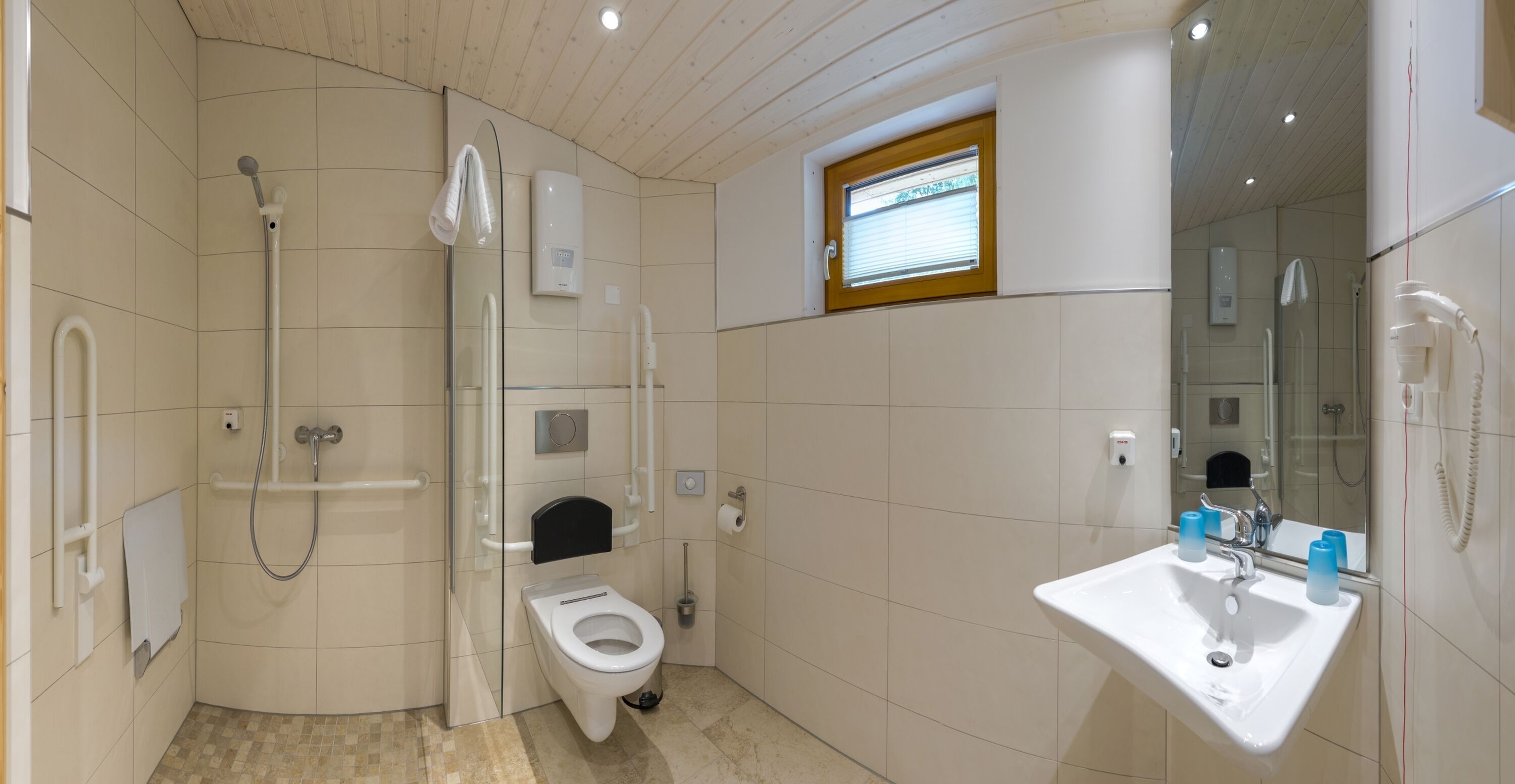 A modern bathroom with a shower, toilet, and sink.