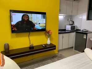 Deluxe Studio | Living area | 24-inch Smart TV with satellite channels