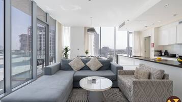 Luxury Apartment | Living area | 65-inch Smart TV with cable channels