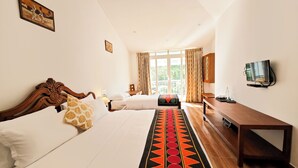 A hotel room with two beds, a TV, a desk, and a window with curtains. - Ibex Resorts, Valparai (Mistly) (Valparai)