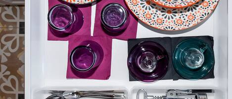 A neatly arranged table setting with plates, glasses, and cutlery.