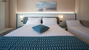 A hotel room with a large bed, two bedside tables, a nightstand, and a painting on the wall. - Hotel Sporting (Vasto)