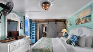 A bedroom with a bed, dresser, and a fan. - Oceanfront Premier King Ste Free Breakfast 8th Flr (Myrtle Beach)