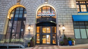 A building with a large arched entrance labeled "CITY CLUB APARTMENTS". - Cincinnati City Club Apartments by Airriva (Cincinnati)