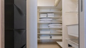 A walk-in closet with multiple shelves and storage bins, organized for easy access. - Modern House Santa Rita by Wonderful Italy (Turin)