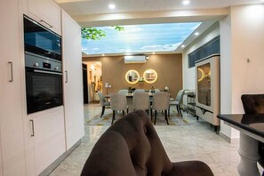 Family Apartment | Living area | 24-inch Smart TV with satellite channels - Lux Suites the Palms Apartments Nyali (Mombasa)