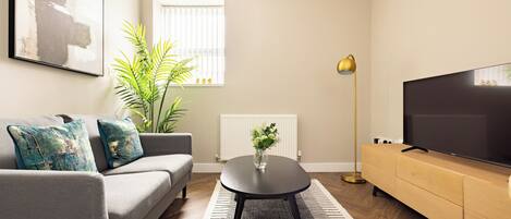 One Bedroom Apartment | Living area | 40-inch Smart TV with digital channels