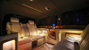 Ein luxuriöses Interieur mit komfortablen Sitzmöglichkeiten, einer Minibar und stimmungsvoller Beleuchtung.