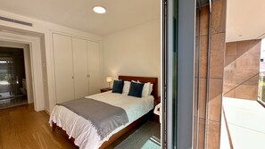 A hotel room with a bed, a nightstand, a lamp, a sliding door, and a view of the outside.