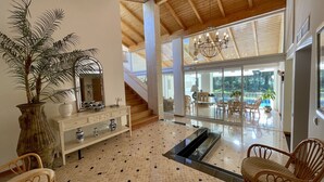 A spacious lobby with a large mirror, a potted plant, a console table, and a staircase leading to an upper level. - Azaleas by Check-in Portugal (Vilamoura)