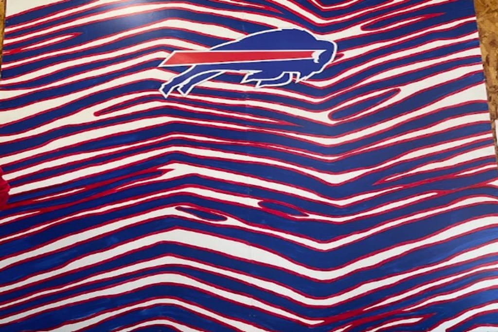 A wall with a buffalo logo and a red and white striped pattern.