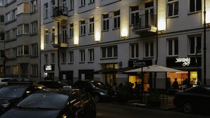 A multi-story building with a restaurant named "Japan Grill" on the ground floor. - Lwowska City Garage (Warsaw)