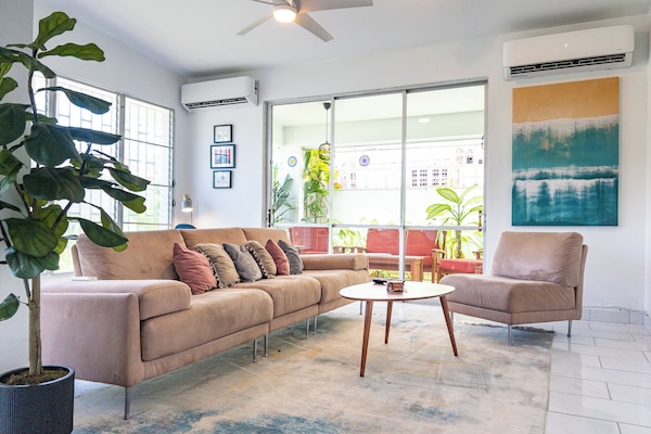 Bright living area with two AC units and an access to the private terrace