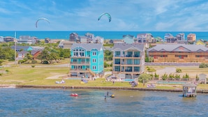 A coastal town with multi-story buildings, a marina, and a beach. - Premier Soundfront w/ Pool, Hot Tub, Elevator, EV Charger, Pickleball, Theater (Rodanthe)