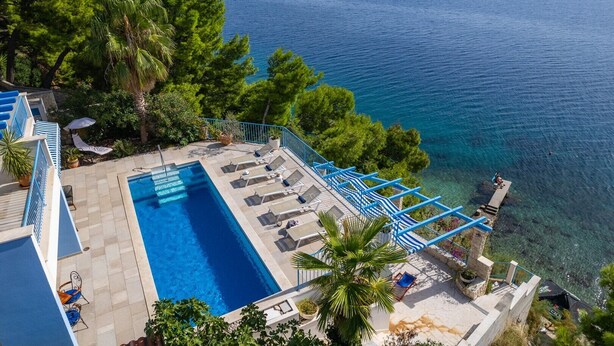 A rooftop pool with clear views of the sea, surrounded by trees and blue railings. - Seafront Villa Azzurro with heated pool, panoramic sea views, walking distance to beach-shop-restaurant (Stanici)