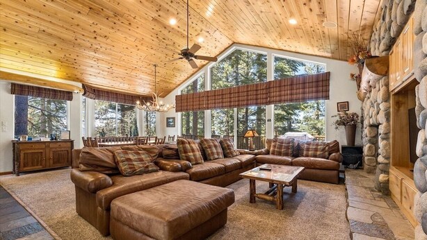 A spacious living room with a large sectional sofa, a coffee table, and a fireplace. - Getting Away Together 6 Bedroom Home by RedAwning (South Lake Tahoe)