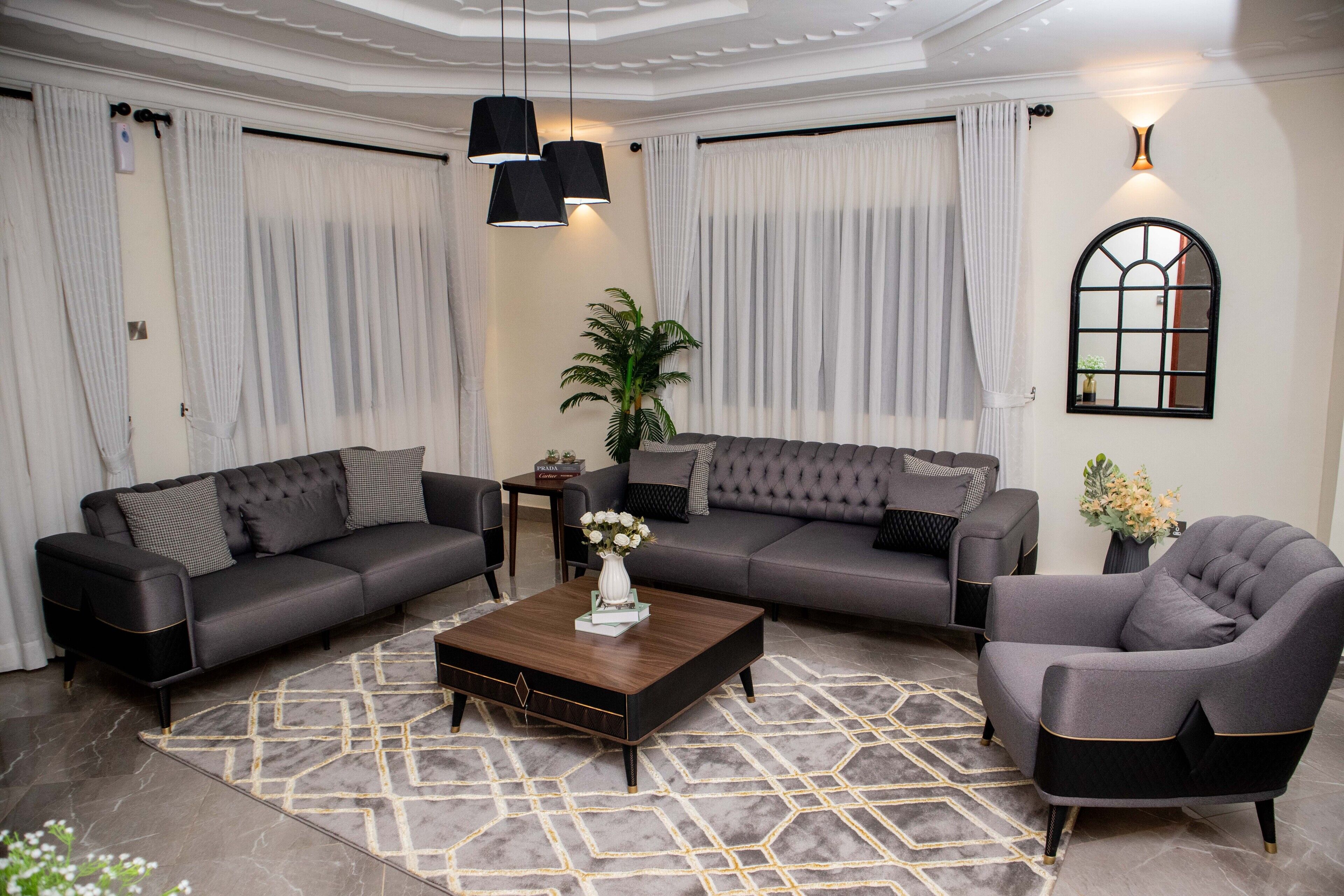 A modern living room with two sofas, a coffee table, and a chair.