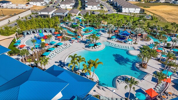 A resort with a large central pool, multiple water slides, and sun loungers. - Villa near Disney 5 bd/4.5bth home 335 (Davenport)
