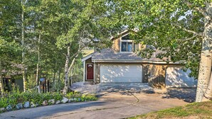 A residential house with a garage, surrounded by trees and a landscaped garden. - Rocky Mountain Retreat: 2 Mi to Beaver Creek! (Avon)