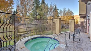 A swimming pool with a metal fence, a bench, and trees in the background. - Luxury Mountain Condo w/ Community Perks & Shuttle (Avon)