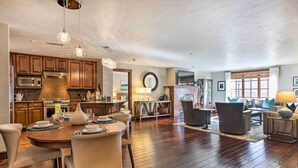 A spacious living area with a dining table, comfortable seating, and a fireplace. - Luxury Mountain Condo w/ Community Perks & Shuttle (Avon)