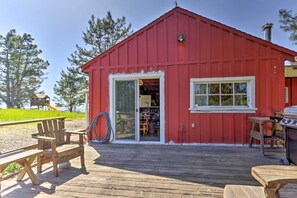 A red building with a wooden deck, a sliding glass door, and a grill outside. - 'moonview Ranch' on 20 Acres in Sonoma County! (Sebastopol)