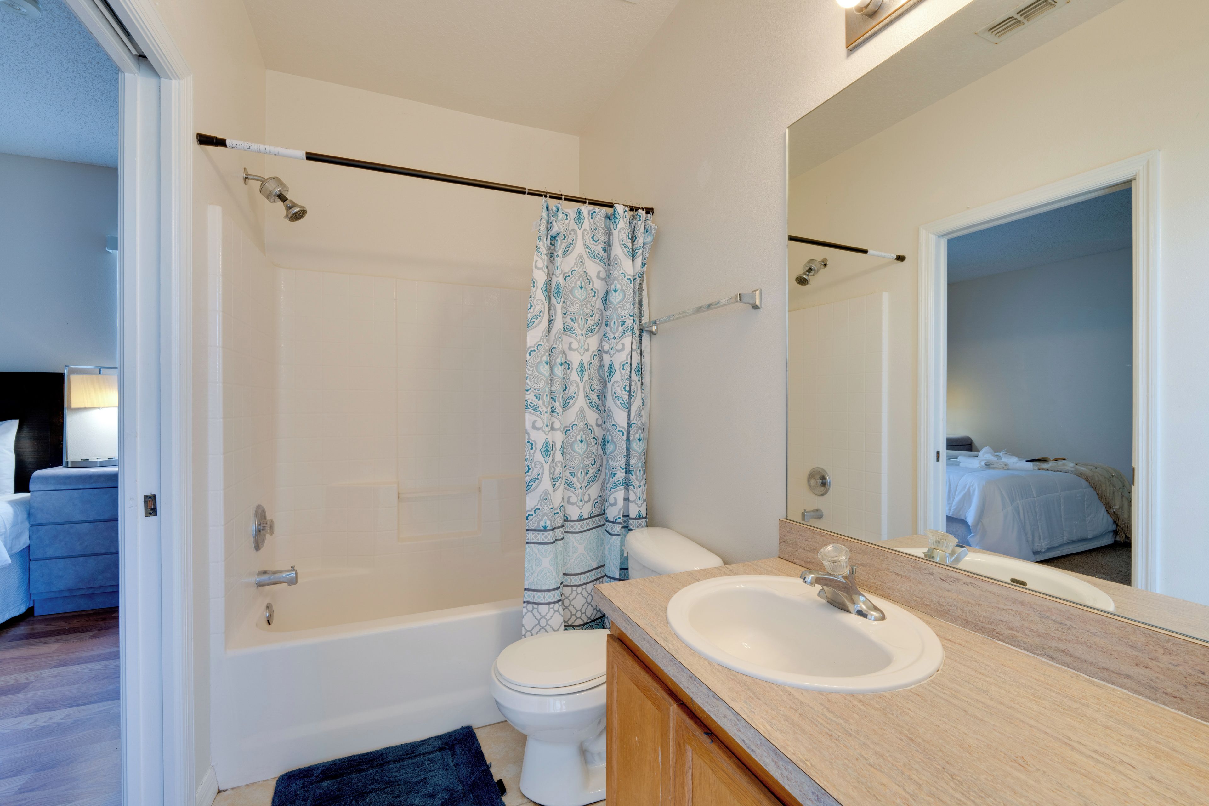 A bathroom with a bathtub, toilet, and sink.
