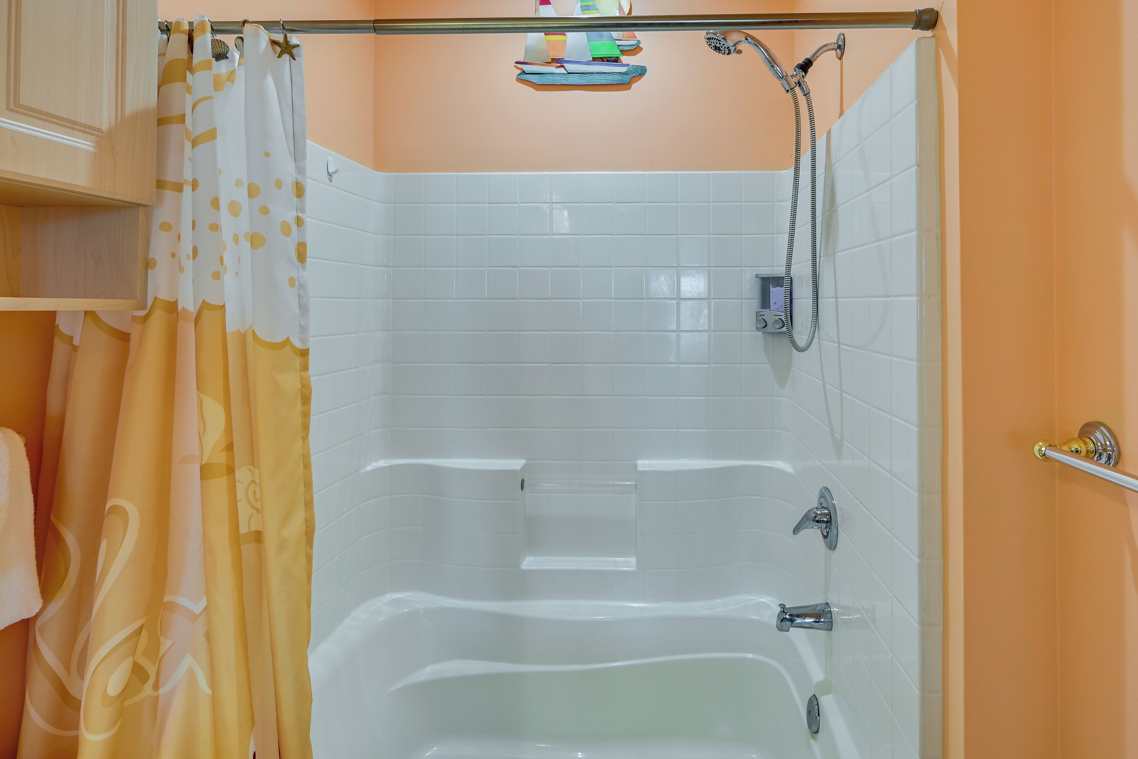A bathroom with a bathtub, a shower, and a toilet.