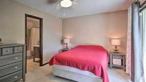 A bedroom with a bed, two bedside tables with lamps, a dresser, a ceiling fan, and a window with curtains. - Lush Gilbert House w/ Outdoor Oasis on Lake Murray (Gilbert)