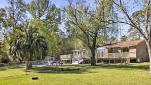 A residential property with a fenced yard, a swimming pool, and a house with a deck. - Lush Gilbert House w/ Outdoor Oasis on Lake Murray (Gilbert)