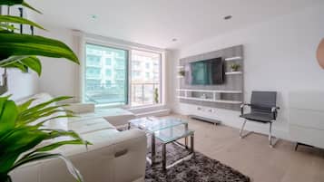 Basic Apartment, Multiple Beds | Living area | TV