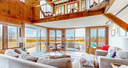 Two-story riverfront retreat with a furnished deck, views, & washer/dryer