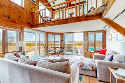 Two-story riverfront retreat with a furnished deck, views, & washer/dryer