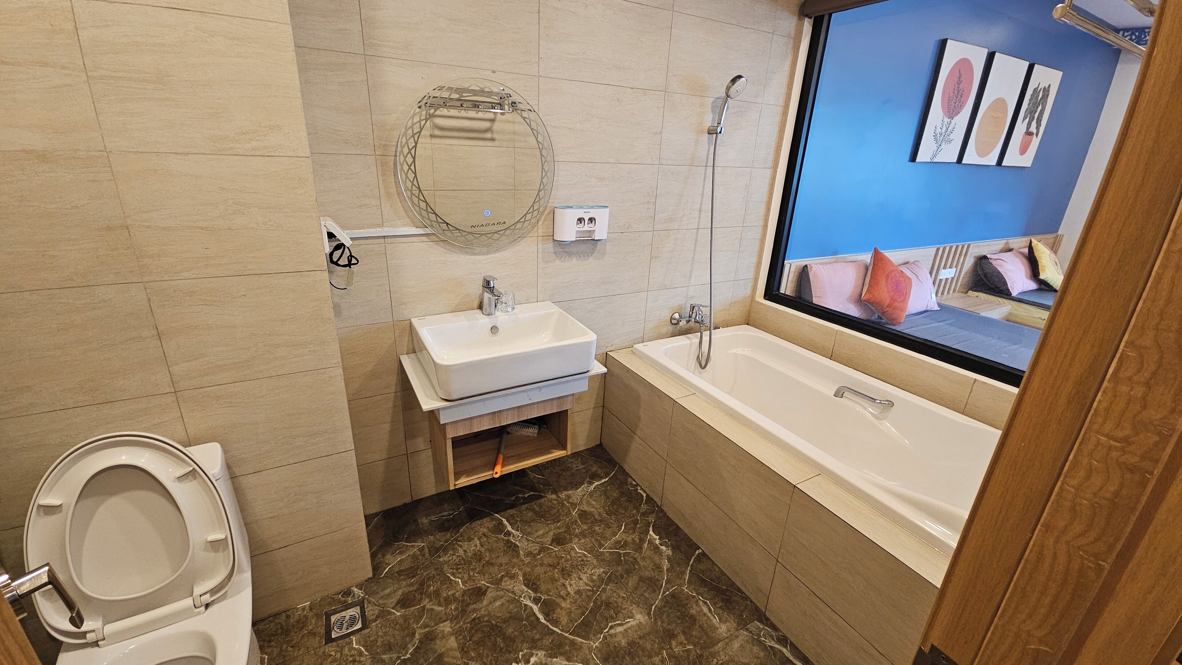 A bathroom with a toilet, sink, and bathtub.