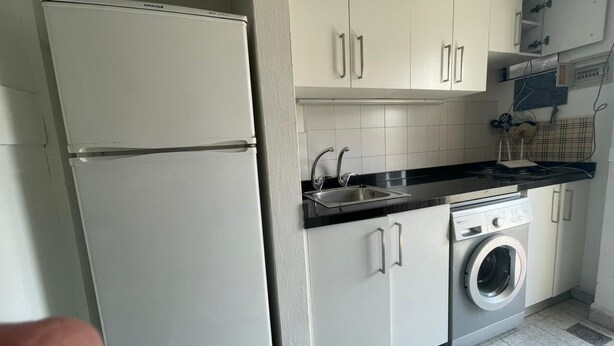 A compact kitchen with a refrigerator, washing machine, and a sink. - Solemar resort, Kaslik, all Fees are included (Kaslik)