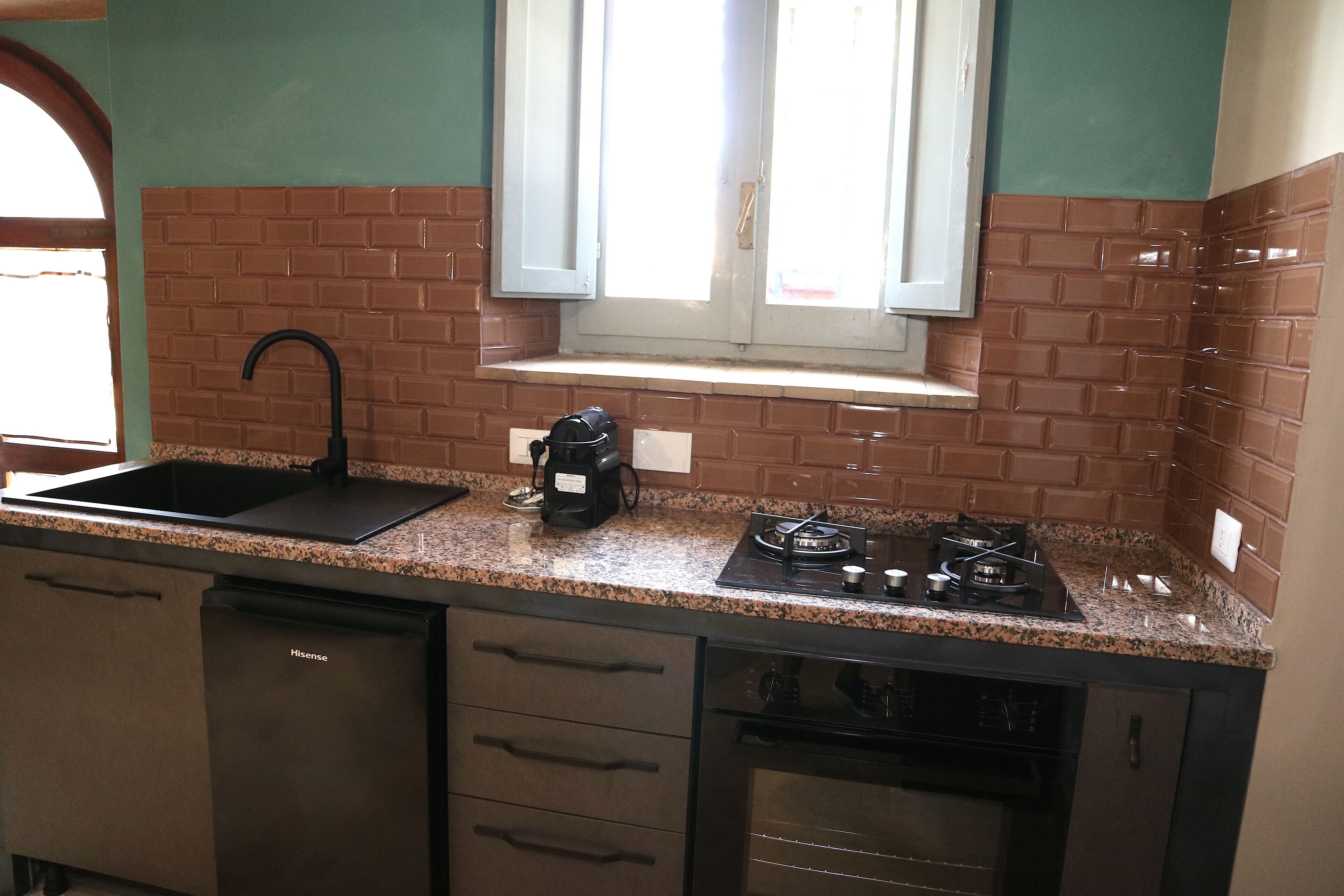 A kitchen with a sink, stove, and dishwasher.