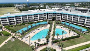A large hotel with multiple swimming pools, a central courtyard, and a view of the ocean. - Completely Remodeled, 2 Kings, Bunkroom, Beach Service  (Miramar Beach)