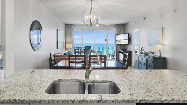 A modern kitchen with granite countertops and a stainless steel sink. - 🌴FAB Gulf Views~Monthly Discount~Walk2Beach~2 Pools~2BR Leeward Key 505🌴 (Miramar Beach)