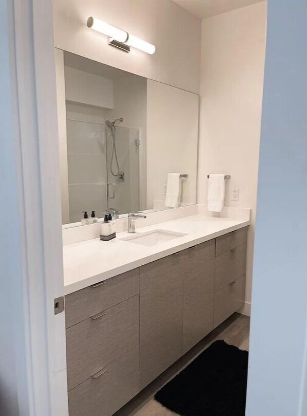 A modern bathroom with a large mirror, a sink, and a shower. - Just Listed! 4 Bed Lux Modern Rambler, Ultra Clean, Office, Centrally located! (Bluffdale)