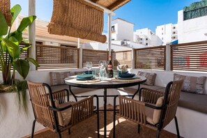 Enjoy meals on the terrace with a view of the surrounding buildings.